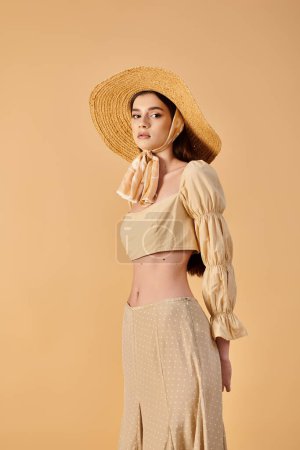 A young woman with long brunette hair radiates summer vibes in a straw hat and dress, exuding elegance and grace.