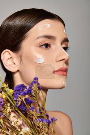 A brunette woman in a studio setting, indulging in a pampering session with copious amounts of cream on her face.