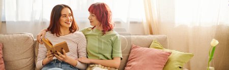 happy lesbian couple with book enjoying quiet moment and looking at each other, banner