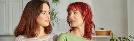 banner of young lesbian couple embracing while looking at each other, their faces full of love