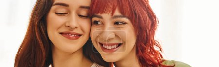 banner of happy moment of cheerful lesbian couple in their 20s smiling at home, comfort and bliss