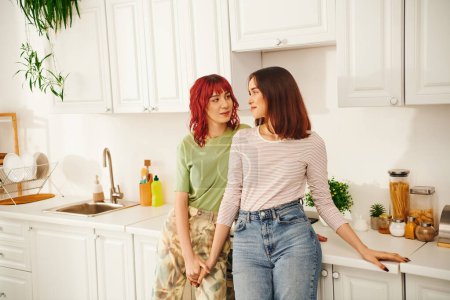Intimate kitchen scene with a loving young lesbian couple sharing a moment of connection, bliss