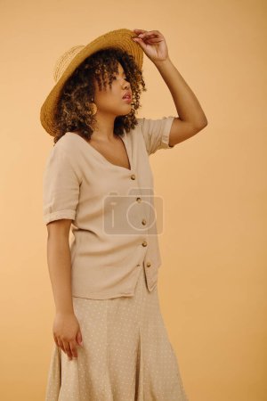 A beautiful young African American woman with curly hair wearing a hat and a dress, exuding elegance and style in a studio setting.