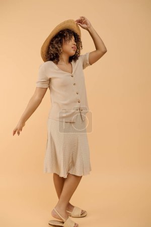 Photo for A stunning African American woman with curly hair, dressed in a summer outfit, striking a pose for a photograph. - Royalty Free Image