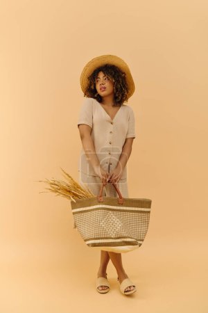 A beautiful young African American woman with curly hair elegantly holding a basket, adorned in a straw hat and summer dress.