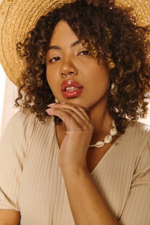 A beautiful young African American woman with curly hair and a straw hat, wearing a summer dress in a studio setting.