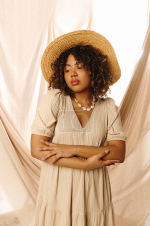A beautiful young African American woman with curly hair, dressed in a summer outfit, striking a pose in a studio setting.