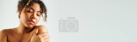 Photo for African American woman gracefully with hands on her shoulder. - Royalty Free Image