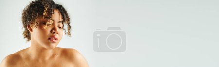 Photo for Beauriful African American woman actively posing on vibrant backdrop. - Royalty Free Image
