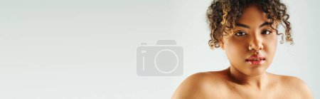 Photo for Attractive African American woman actively posing on vibrant backdrop. - Royalty Free Image
