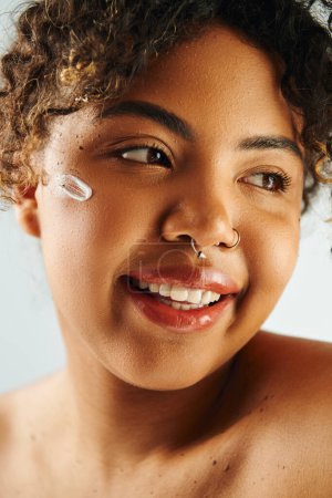 Photo for A beautiful African American woman strikes a pose, showcasing her nose ring. - Royalty Free Image