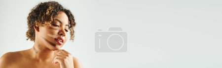 Photo for Stylish African American woman with foundation on face poses against vibrant backdrop. - Royalty Free Image