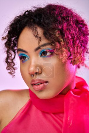 Photo for A beautiful African American woman energetically posing in a vibrant pink top. - Royalty Free Image