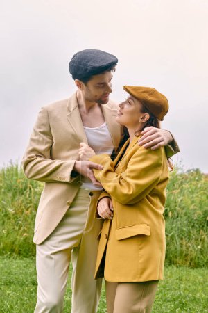 Ein Mann und eine Frau teilen einen zärtlichen Moment in einem malerischen Feld, umgeben von viel Grün und der Schönheit der Natur.