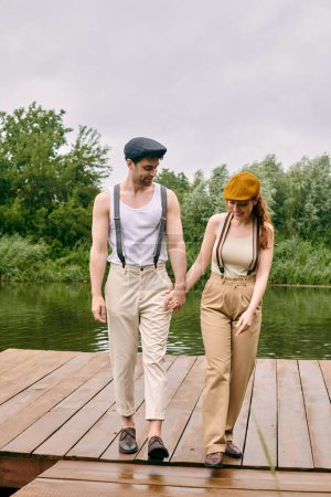 A man and a woman enjoy a romantic stroll along a dock in a serene green park setting.
