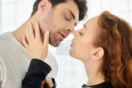 A man and a woman share a loving kiss in an intimate moment.