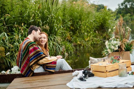 A couple in boho style attire enjoying a romantic boat ride in a serene green park setting.