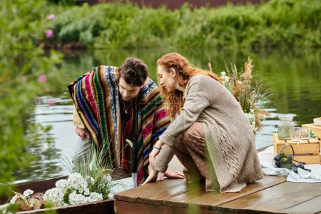 A stylish bohemian couple enjoying a boat ride in a lush green park on a romantic date.