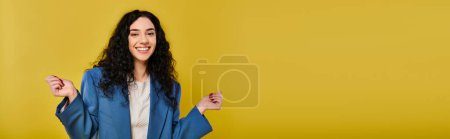 Téléchargez les photos : Une jeune femme aux longs cheveux noirs pose avec confiance dans une veste bleue élégante, respirant un air de joie et d'élégance. - en image libre de droit