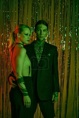 Photo for Couple standing together at a lively rave party or nightclub - Royalty Free Image