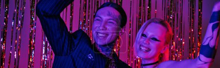 Téléchargez les photos : Un homme et une femme debout côte à côte dans une rave-party animée ou une boîte de nuit rave - en image libre de droit
