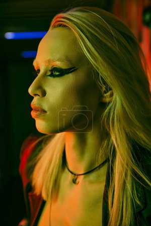 Woman with vibrant long blonde hair and bold black makeup