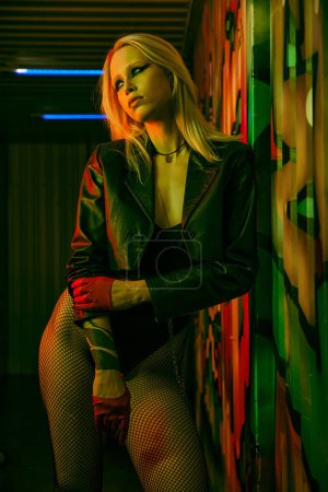 Photo for A woman wearing a leather jacket and fishnet stockings - Royalty Free Image