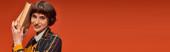 banner of cheerful college girl in uniform holding books near face on orange background, knowledge hoodie #712420180