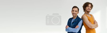 Photo for Joyful lgbtq friends in stylish outfits posing on gray backdrop and looking at camera, banner - Royalty Free Image
