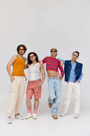 four fashionable cheerful gay friends with stylish sunglasses posing actively together, pride month