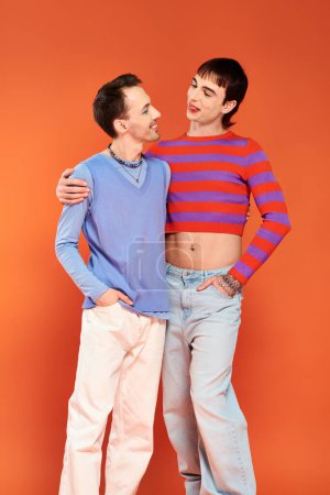 Photo for Happy attractive gay friends with vivid makeup posing together on orange backdrop, pride month - Royalty Free Image
