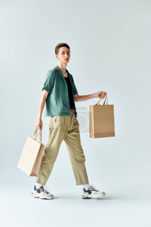 A young man exudes confidence while walking with shopping bags in hand, showcasing his trendy style.