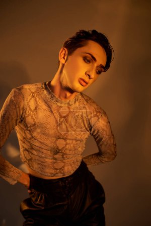 Photo for Young queer person donning a black top and leather pants striking a confident pose. - Royalty Free Image