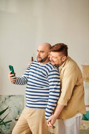 A gay couple taking a selfie with a cell phone.