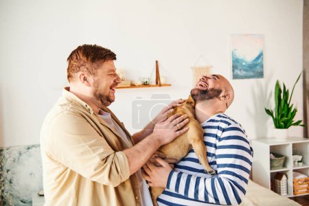 A man lovingly holds a French Bulldog in a cozy living room setting.