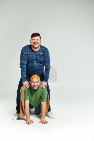 Photo for Two men engaging in playful acrobatics. - Royalty Free Image
