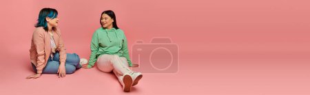 Photo for An Asian mother and her teenage daughter, sit on the ground engaging in meaningful conversation. - Royalty Free Image