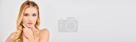 Photo for Woman posing gracefully with hands on face. - Royalty Free Image