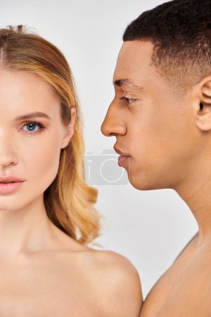 Photo for A loving trendy couple engaging in a skin care routine, looking deeply into each others eyes. - Royalty Free Image