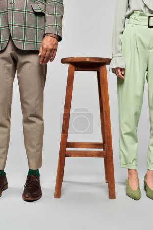 Photo for Couple posing gracefully next to stool. - Royalty Free Image