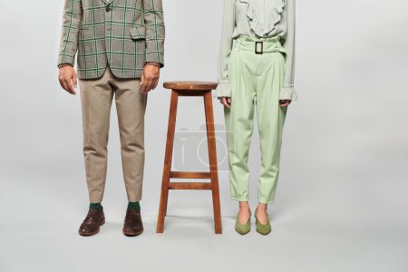 Foto de A man and woman affectionately pose next to a stool. - Imagen libre de derechos