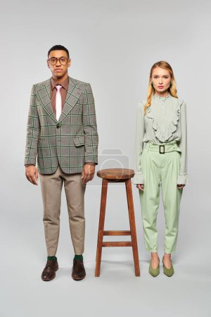 Téléchargez les photos : A stylish man and woman pose near a stool. - en image libre de droit
