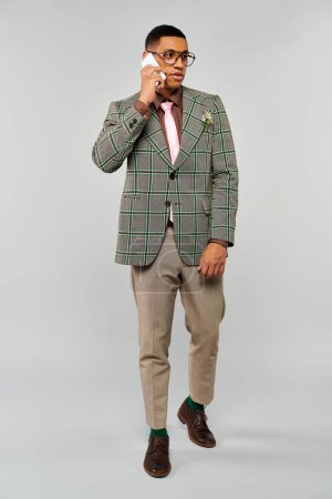 Photo for A man in a plaid blazer talking on a cellphone. - Royalty Free Image
