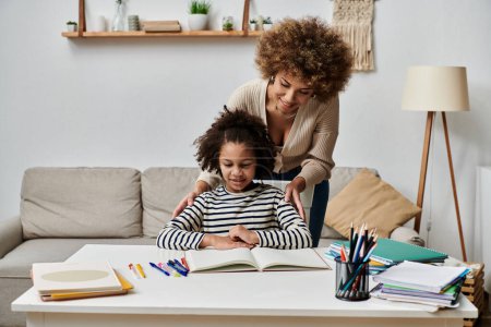 Happy African American mother and daughter study together at home, focusing on homework.