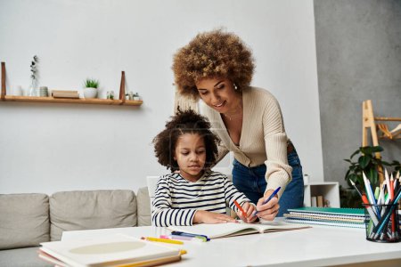 An African-American mother lovingly helps her daughter with homework, creating a bond and fostering learning.