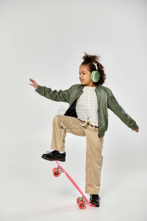 A young girl with headphones rides a skateboard.