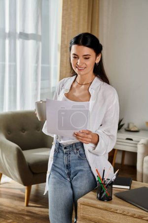 A woman standing in the living room, holding a piece of paper.