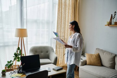 Stylish woman working from home, holding important document in cozy room.