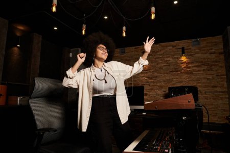 A woman joyfully stretches her arms in a recording studio during a music band rehearsal.
