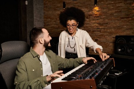 A man and a woman collaborate in a recording studio, immersed in creating music for their band rehearsal.